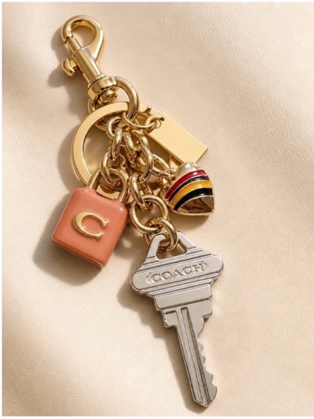 Coach Gold-Tone Key & Charm Cluster with Pink Enamel Bag Accent